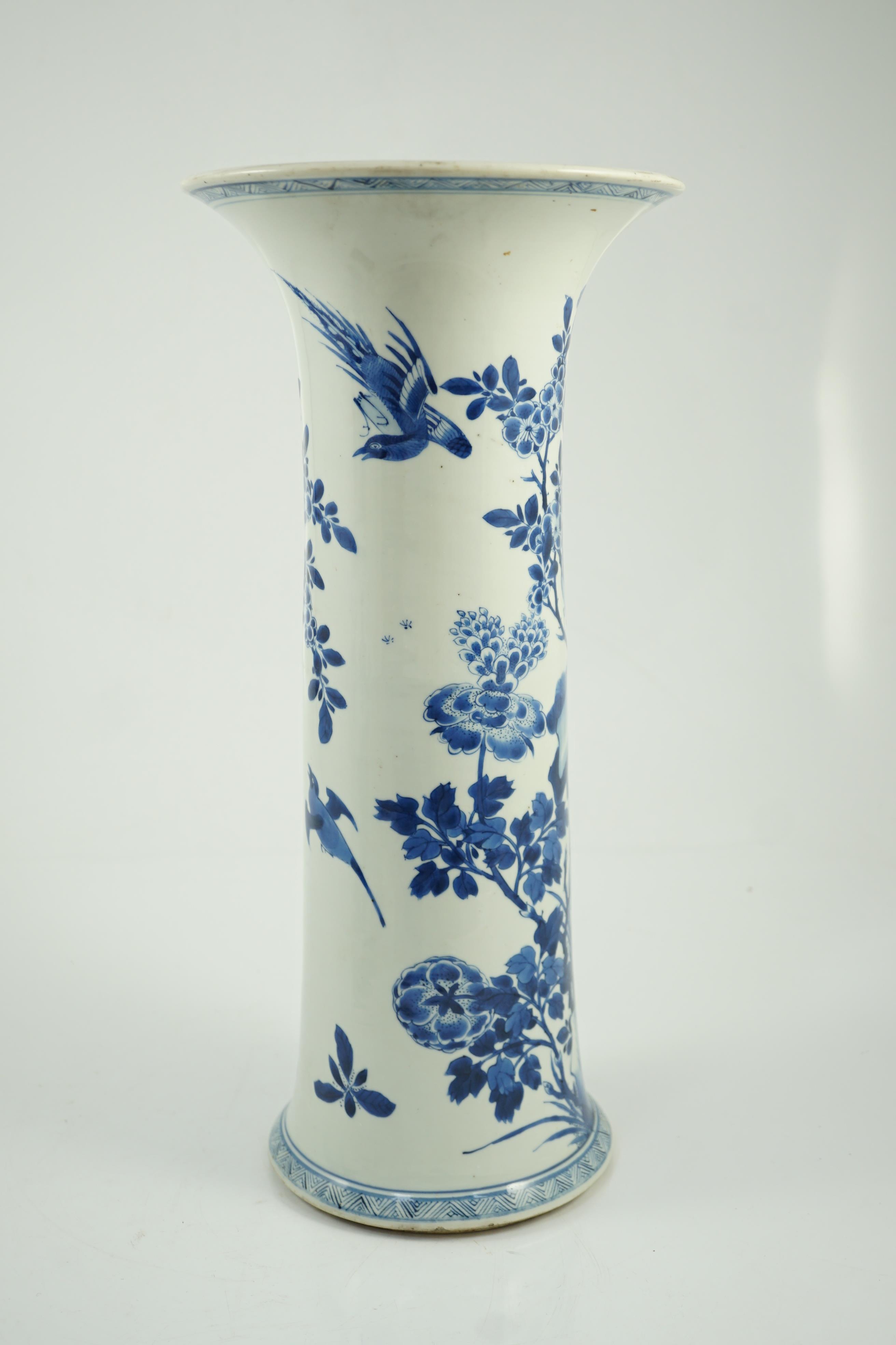 A tall Chinese blue and white ‘pheasants and rocks’ beaker vase, gu, Kangxi period, minor faults